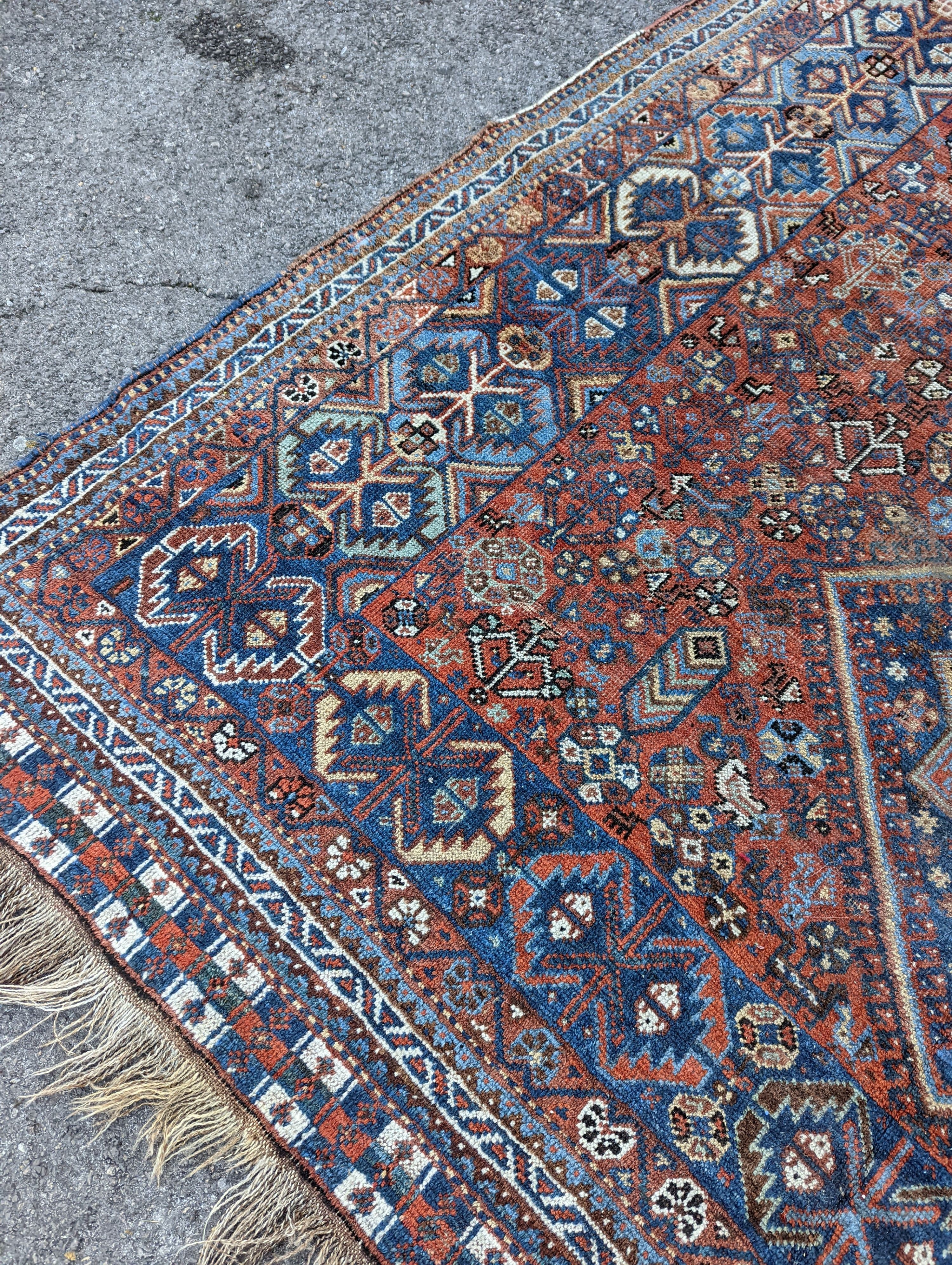 A Caucasian red ground carpet, 295 x 220cm